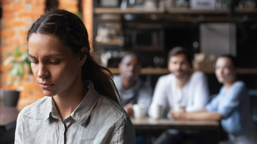 Sad Woman Being Ostracised by a Group of Three People